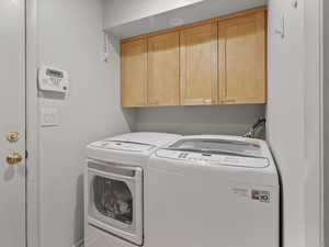Laundry room featuring cabinet space and washing machine and clothes dryer