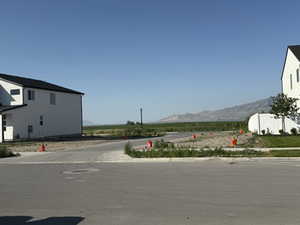 View of asphalt street featuring a mountain view