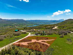 Aerial view of property's location featuring property parcel outlined and a water and mountain view
