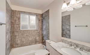 Bathroom featuring vanity and washtub / shower combination