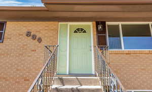Doorway to property with brick siding