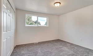 Unfurnished bedroom with carpet and a closet