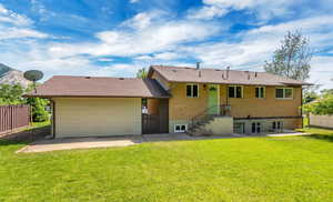 Rear view of property with a patio and brick siding