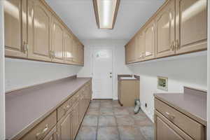 Washroom featuring cabinet space and washer hookup