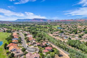 Aerial view of residential area featuring a water and mountain view and a golf club