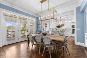 Dining room featuring crown molding and a chandelier