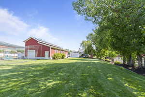 View of yard with an outdoor structure and a garage