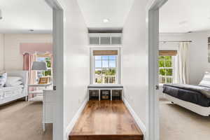 Corridor featuring wood finished floors and baseboards