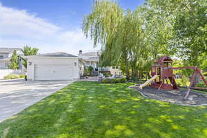 View of yard featuring a playground and driveway