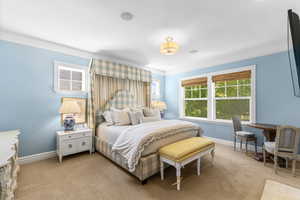 Bedroom featuring light colored carpet and baseboards