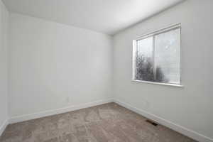 Spare room with carpet flooring and baseboards