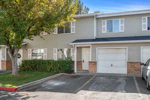 Traditional-style house featuring brick siding and asphalt driveway