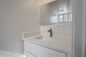 Bathroom featuring vanity and a textured ceiling