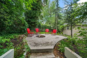 View of patio featuring a fire pit and a shed