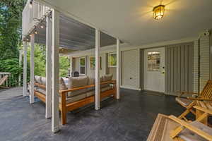 Entrance to property featuring an outdoor hangout area, brick siding, and a patio area