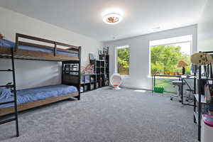 Carpeted bedroom featuring baseboards