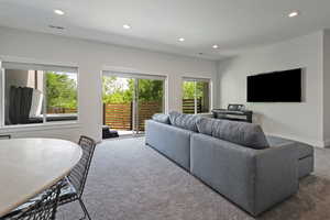 Living area with carpet and recessed lighting