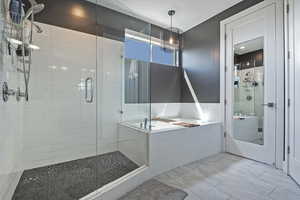 Bathroom with a stall shower, a bath, and tile patterned floors