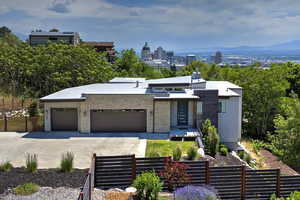 Modern home with an attached garage, concrete driveway, and stucco siding