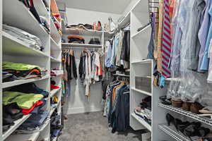 Walk in closet featuring carpet flooring