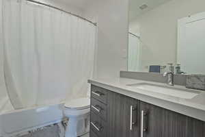 Bathroom with vanity and shower / bath combination with curtain