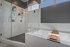 Full bath featuring a shower stall and a garden tub