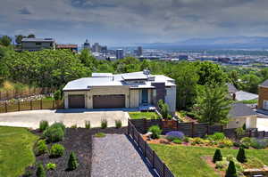 Modern home featuring driveway, a garage, and stucco siding