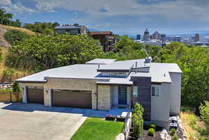 Modern home with concrete driveway, an attached garage, and stone siding