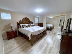 Bedroom featuring light wood finished floors and a closet