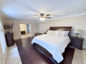 Bedroom featuring crown molding and a ceiling fan