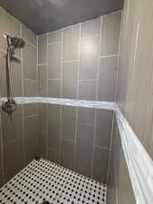 Full bathroom with a tile shower