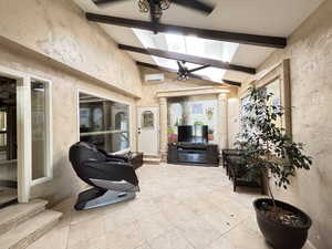 View of entry with an AC wall unit and ceiling fan