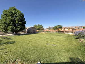 Fenced backyard with a storage shed