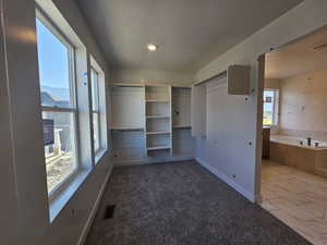 Unfurnished bedroom with a textured ceiling, marble look tile flooring, and recessed lighting