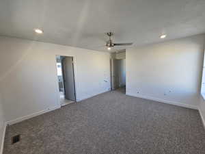 Unfurnished room featuring ceiling fan, carpet, a textured ceiling, and recessed lighting