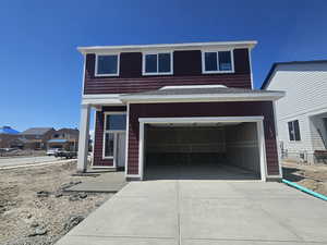 View of front of property featuring driveway and a garage