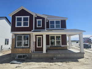 View of front of property with a porch and board and batten siding