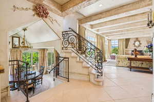 Stairs featuring tile patterned floors and beam ceiling
