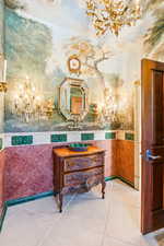Bathroom with a chandelier, tile patterned flooring, and vanity