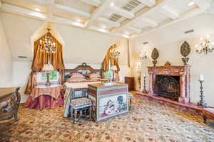 Bedroom with a chandelier, beamed ceiling, coffered ceiling, a premium fireplace, and recessed lighting