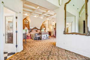 Bedroom with carpet floors, a chandelier, and beam ceiling