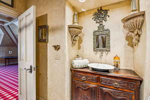 Bathroom featuring vanity and a textured wall