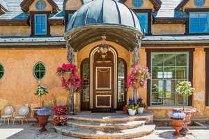 Doorway to property with stucco siding