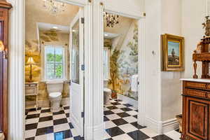 Bathroom featuring tile patterned floors, vanity, and a chandelier