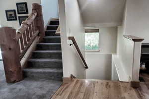 Stairs featuring wood finished floors
