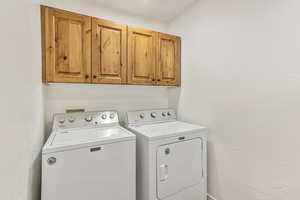 Laundry area with cabinet space and washer and dryer