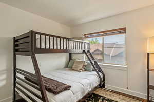 Bedroom with baseboards and wood finished floors