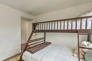 Bedroom featuring baseboards and wood finished floors