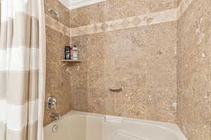 Full bath featuring shower / bath combo with shower curtain