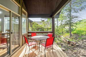Wooden terrace featuring outdoor dining area
